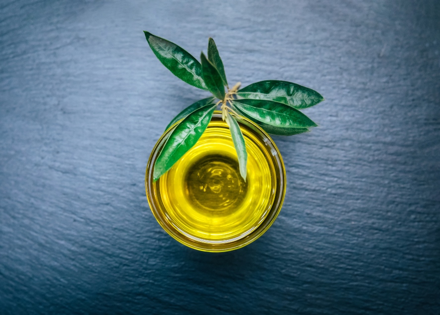 Small glass bowl of cold pressed oil viewed from the top