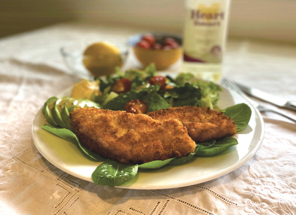Classic chicken schnitzel on a plate with salad