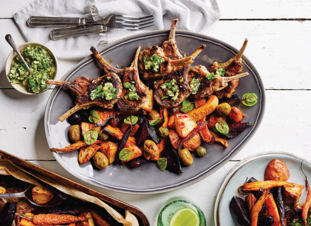 A beautifully arranged platter of frenched lamb cutlets and root vegetables.